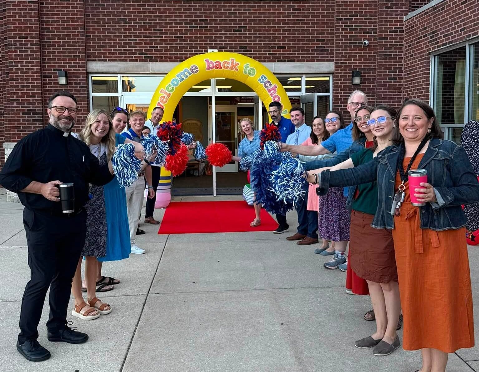 Teachers standing outside of St. Paul's Lutheran School to welcome back students for the school year